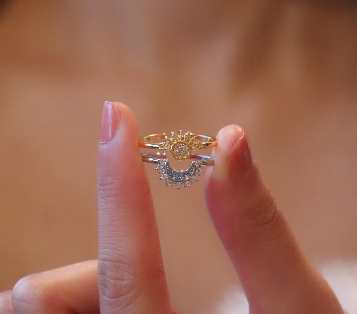 A Sun and Moon silver ring with a design