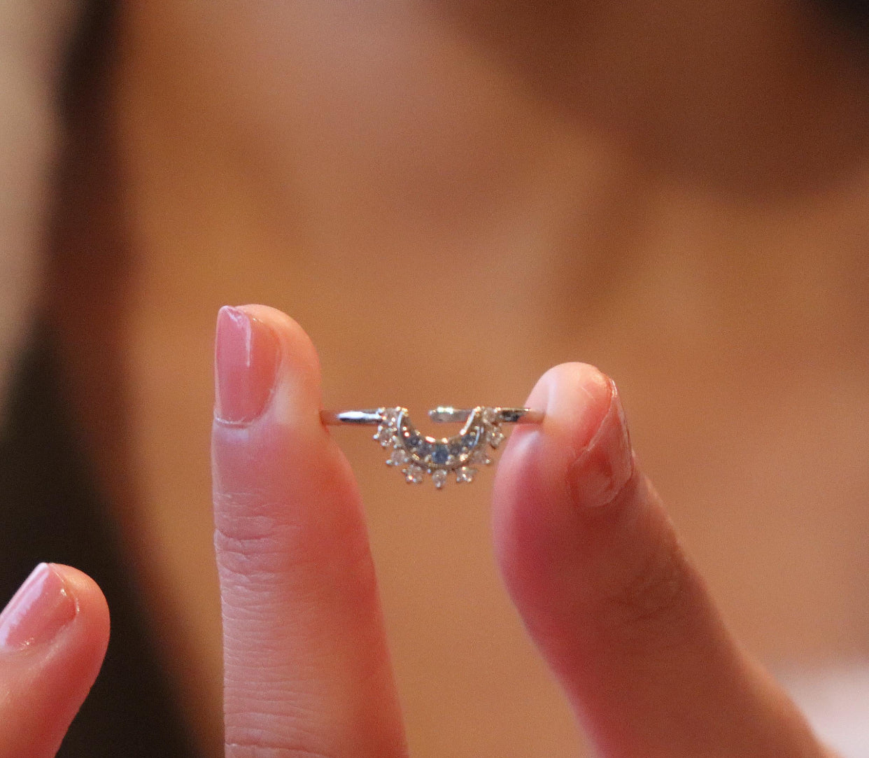 A Sun and Moon silver ring with a design